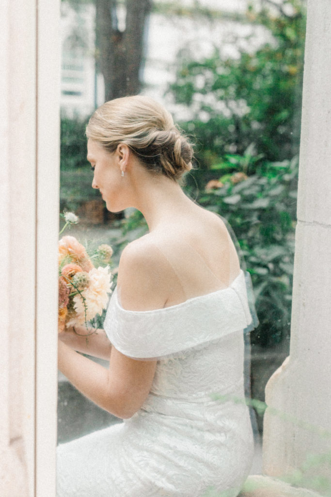 Bride sits on windowsill in New York City
