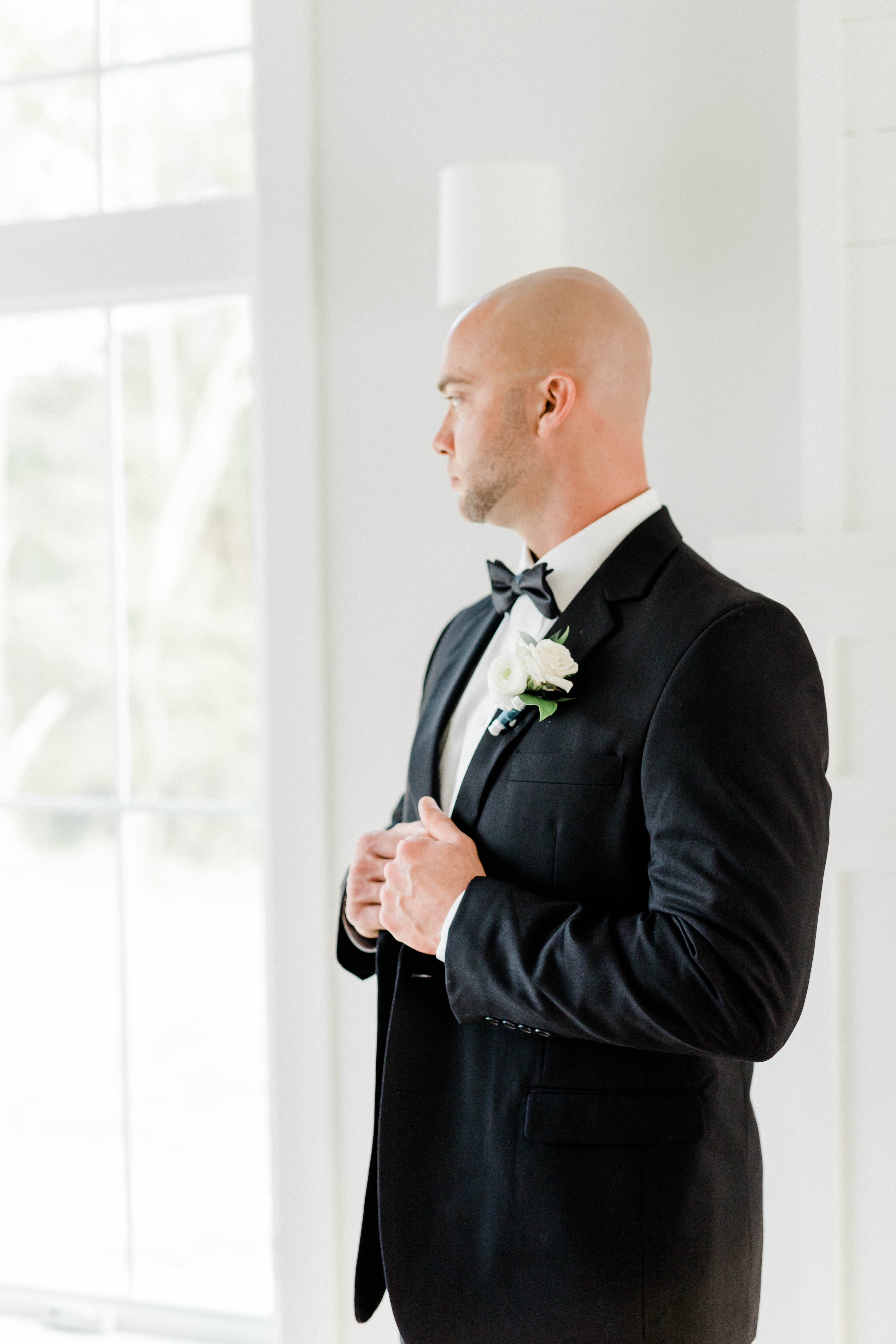 Groom at window - Natural Light - Black Tuxedo - Elegant Wedding - Fine Art
