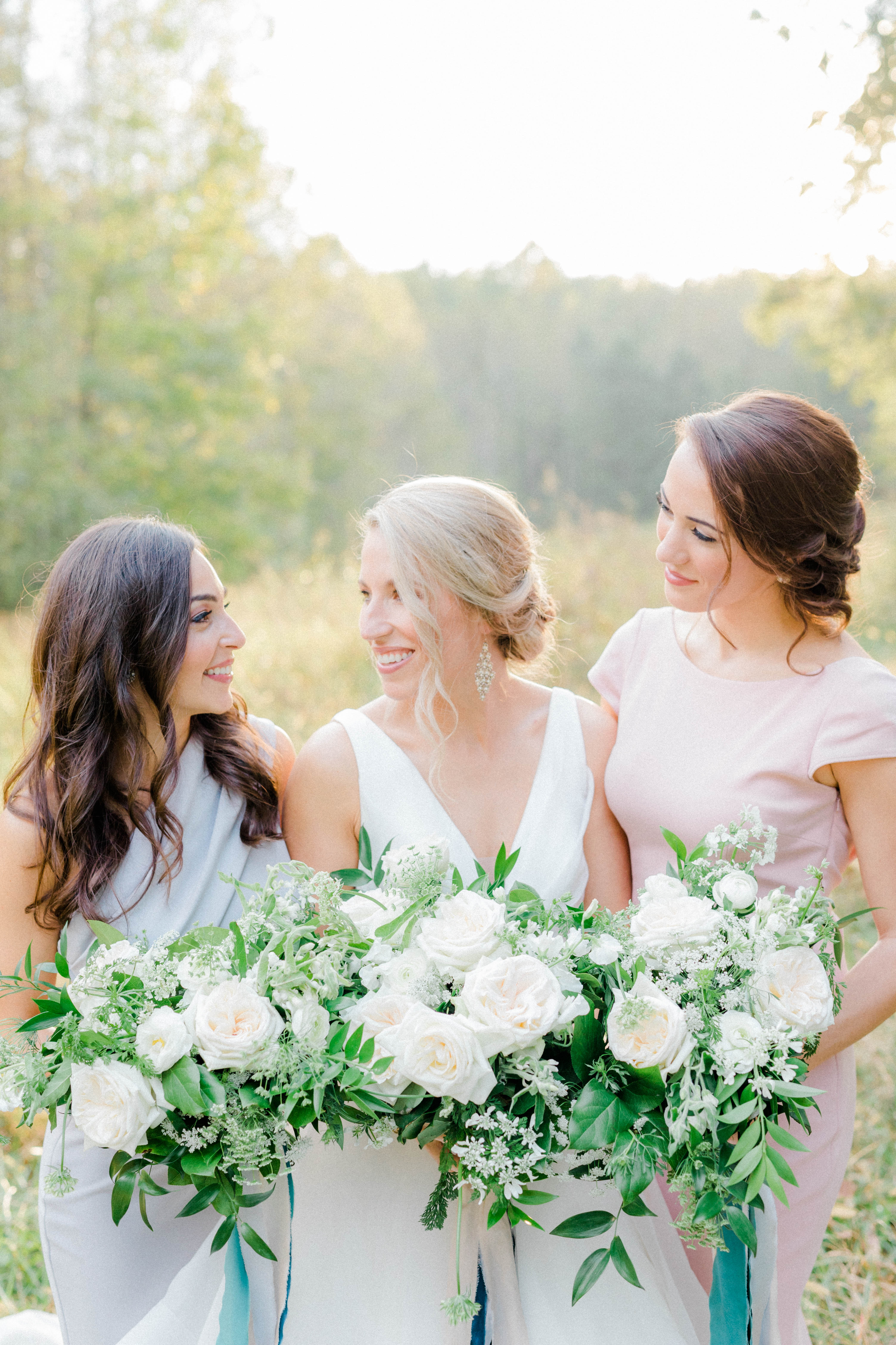 Bride and bridesmaids in a field in autumn, blush gray and teal wedding colors, blush color palette, blush ribbon