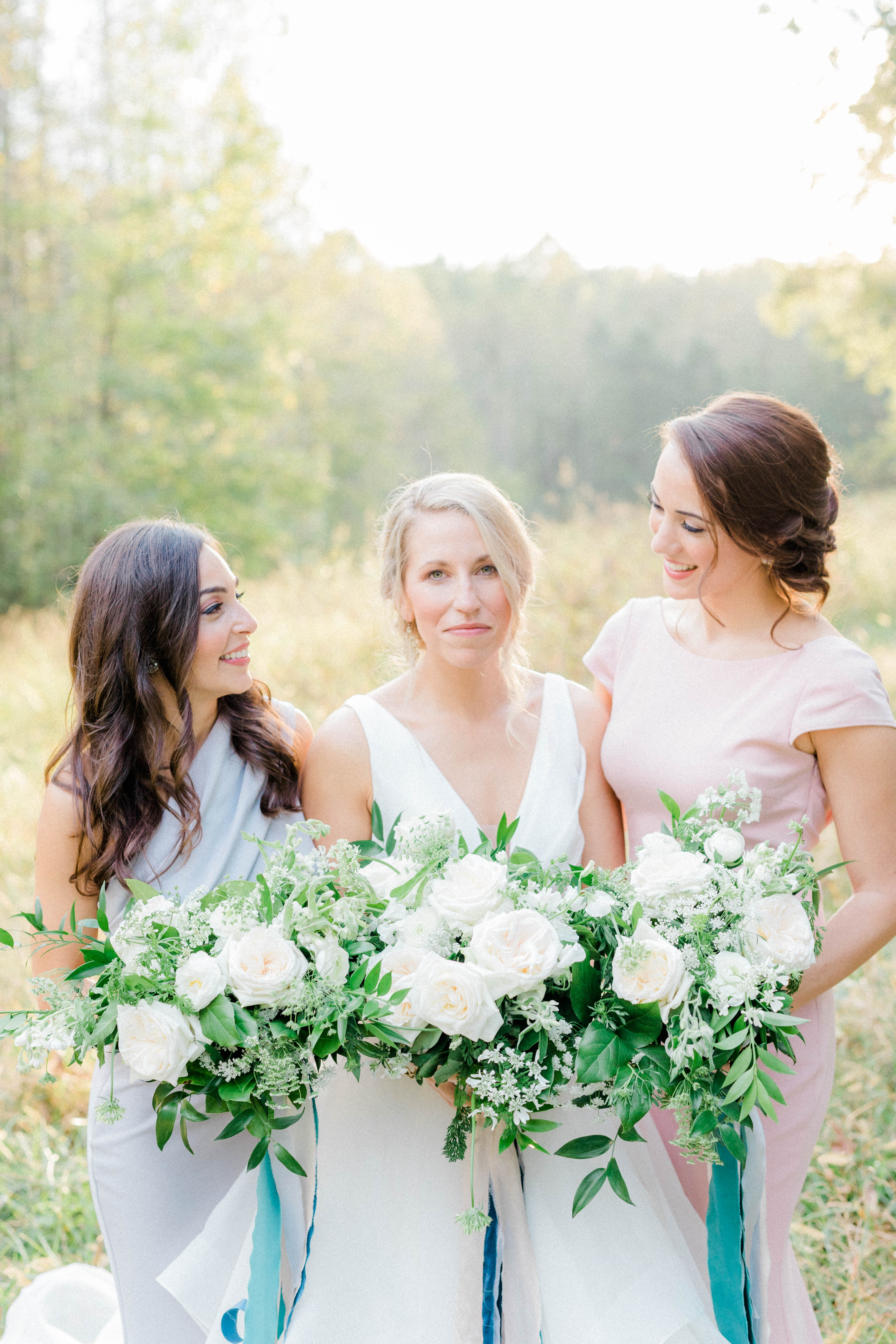 Bride and bridesmaids in a field in autumn, blush gray and teal wedding colors, blush color palette, blush ribbon