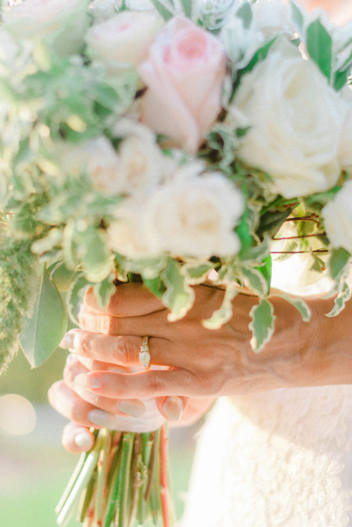 Wedding Ring on Brides Hand as she Hold Bouquet