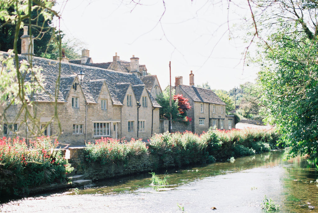 A row of homes along the water in in the town of Bibury, in the Cotswolds England