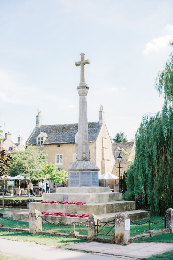 World War I and II Memorial cross on High street in the village of Burton on the water in England