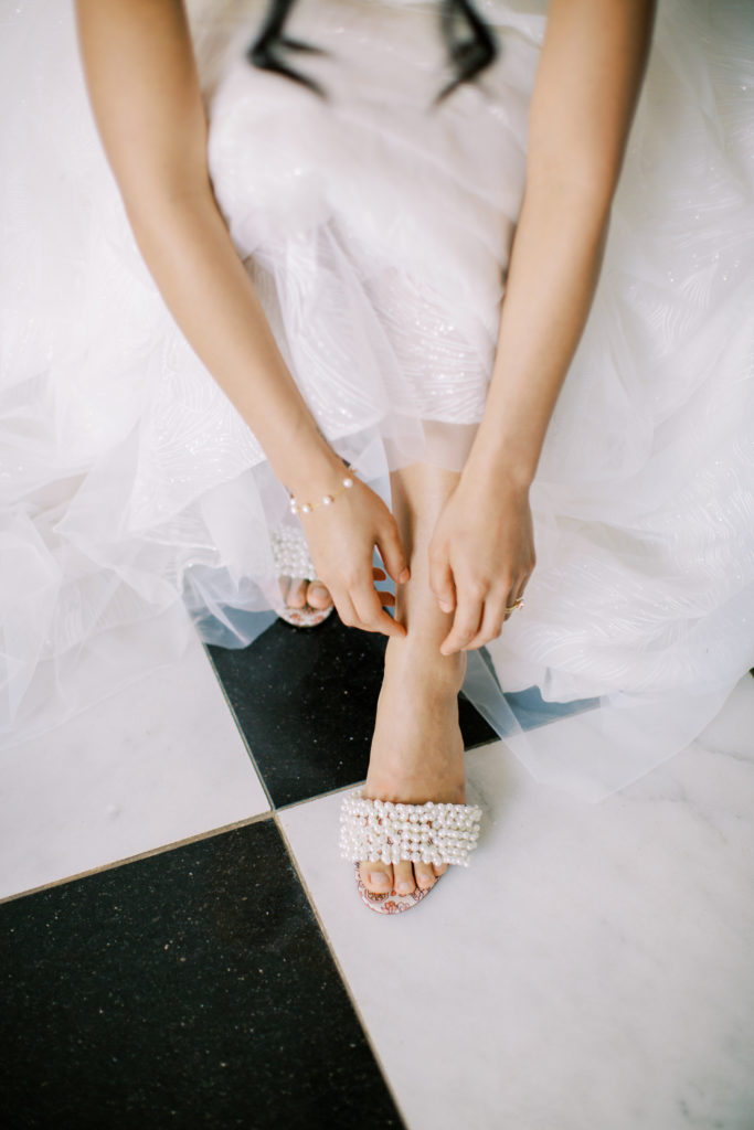bride adjusts shoes in bridal suite at Lauxmont farms in Wrightsville PA