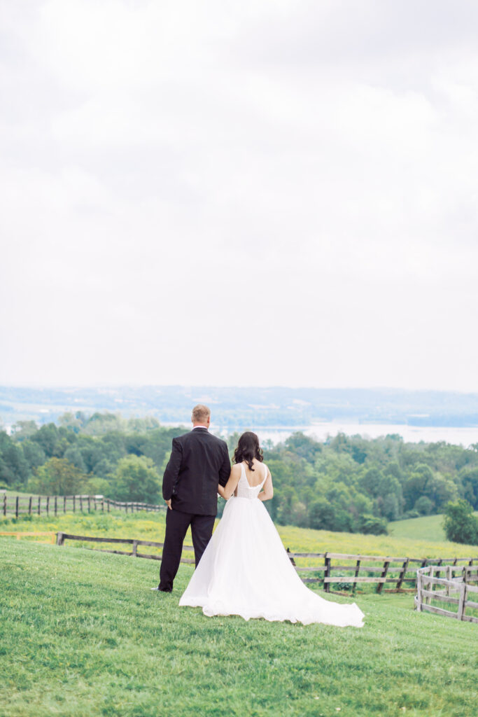 Bride and groom stand on hilltop at Lauxmont Farms in Wrightsville PA