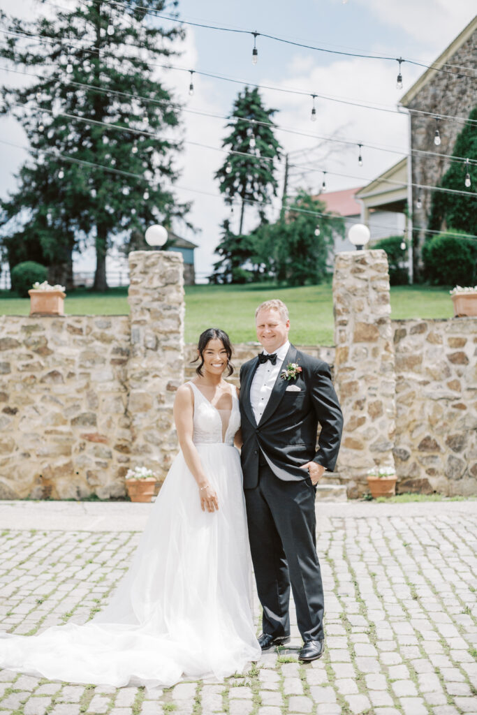 Bride and groom stand in the courtyard at Lauxmont Farms in Wrightsville, PA