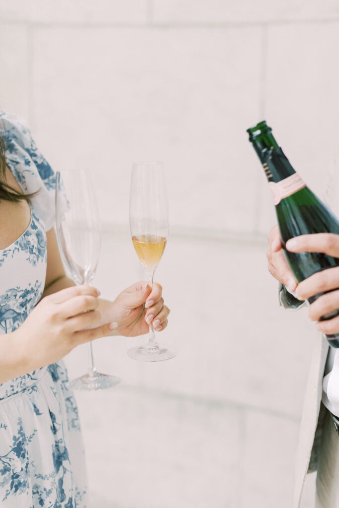 Couple prepare to toast at their engagement session